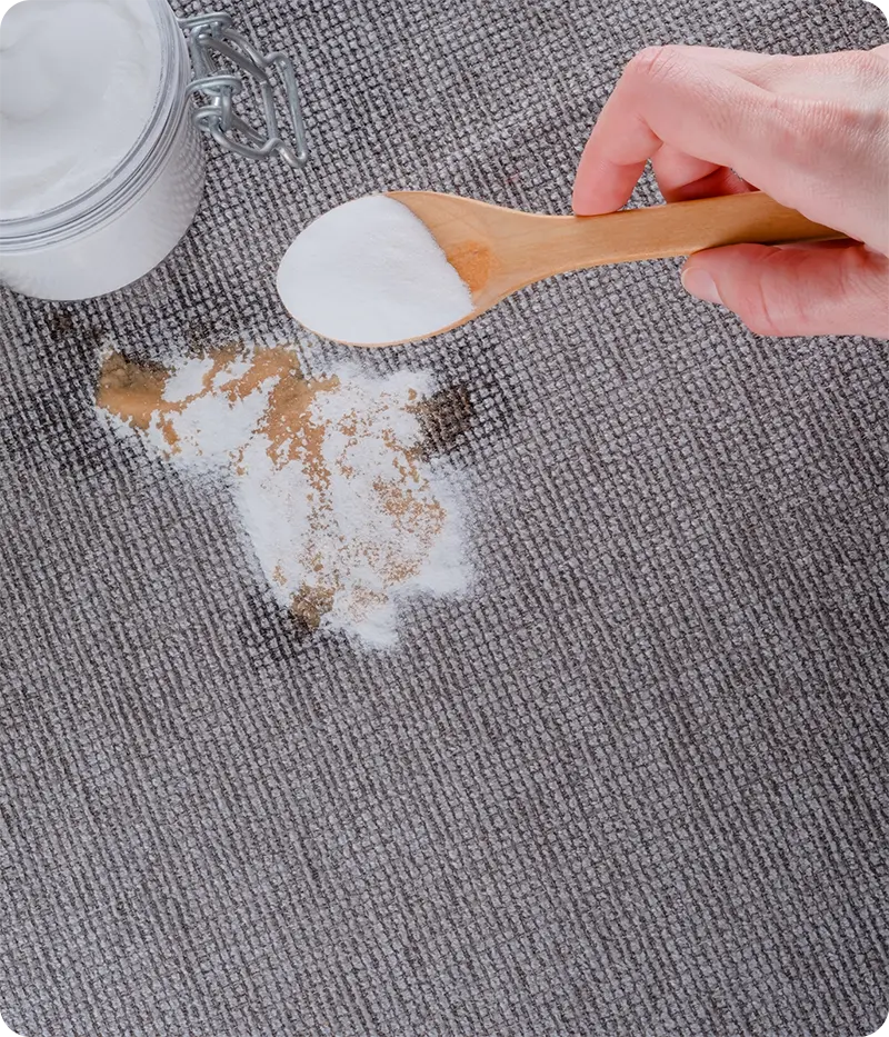 Using baking soda paste for stain removal on clothing