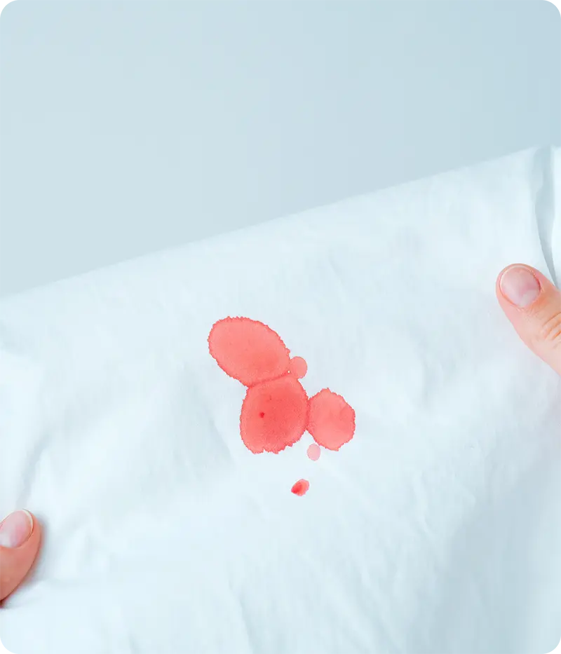 Cleaning blood stains from clothes using cold water and liquid detergent